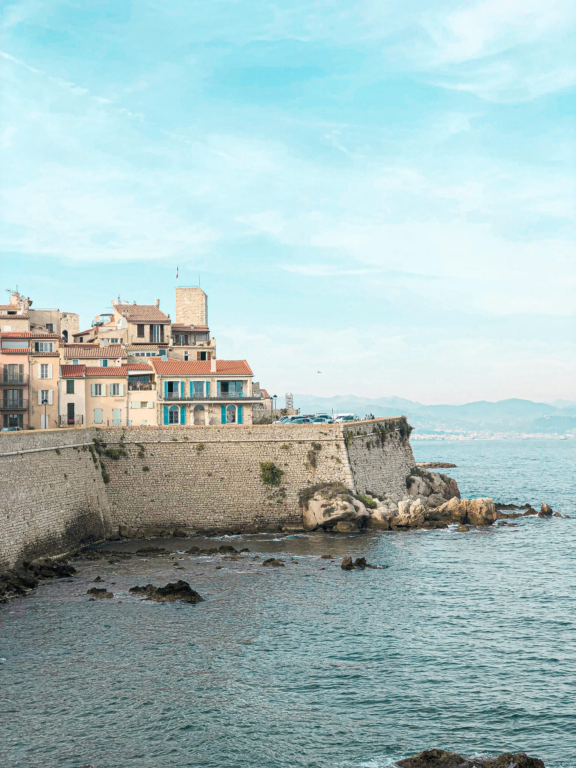 Medieval ramparts of Antibes, France, overlooking the Mediterranean Sea with the Maritime Alps in the distance.