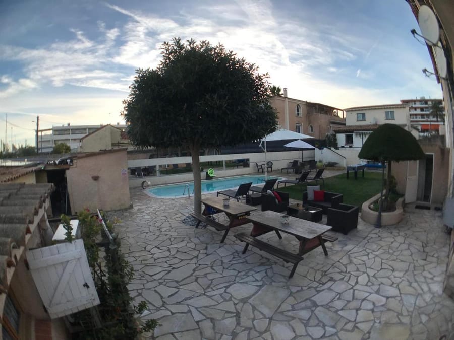 Exterior of Debbie's Crew House, a Provençal villa with gated courtyard.