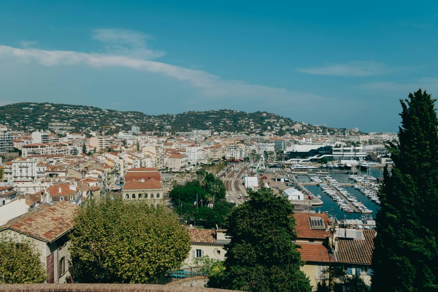 Aerial view of Cannes harbour, cityscape and Mediterranean coastline.