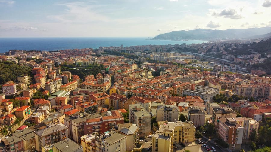 Seaside promenade in Liguria, Italy, lined with palm trees on the Italian Riviera.